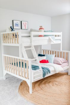 a white bunk bed sitting on top of a rug