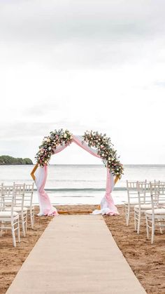 a wedding ceremony setup on the beach