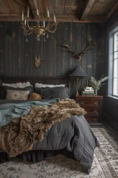 a rustic bedroom with wood paneling and deer head mounted on the wall above the bed