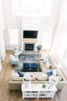 a living room filled with furniture and a fire place in the middle of the room