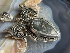 "This listing is for a  blue labradorite dragon pendant. It has been made with a two-headed Norse- style dragon, adorned with a small Marcasite Agate.  This Necklace comes with a 24\" Stainless steel chain, which I can customize at the time of purchase, just leave me a note at checkout. All jewelry ships in a sturdy gift box, and will arrive ready for gift-giving. In Many cases, I can accommodate special or custom orders, simply message me, and I will do my best to help get you what you need, wh Nordic Dragon, Serpent Necklace, Two Heads, Celtic Knotwork, Dragon Pendant, Blue Labradorite, Agate Crystal, Steel Chain, Stainless Steel Chain