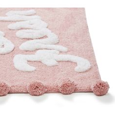 a pink rug with white letters on it