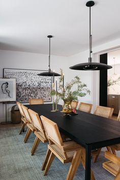 a dining room table with chairs and lights