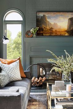 the living room is decorated in shades of gray and orange, with an open fireplace