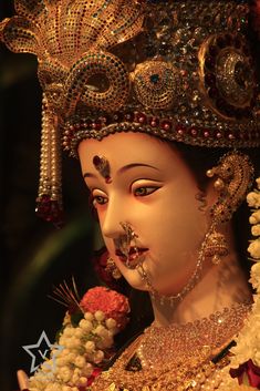 a close up of a statue with jewelry on it's face