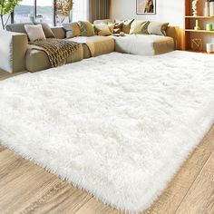 a large white rug in the middle of a living room