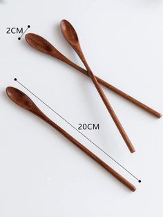 three wooden spoons are shown with measurements for the size and shape on each spoon