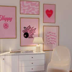 a white dresser sitting next to a wall with pictures on it and a lamp in front of it