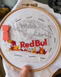 someone is holding up a redbull embroidery project