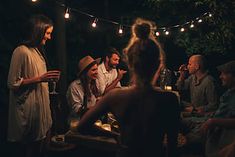 a group of people sitting around a table at night