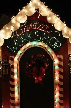 a lit up entrance to a house with christmas lights on it