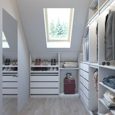 a walk in closet with lots of white drawers and shoes on the shelves next to it