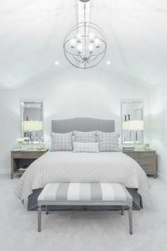 a bedroom with a bed, dressers and mirror in it's center area