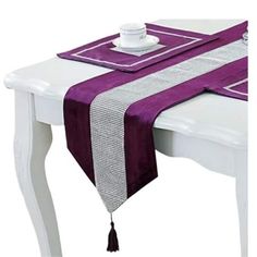 a table with a purple and white runner on it