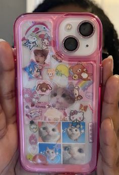 a person holding up a phone case with pictures on it and stickers on the back