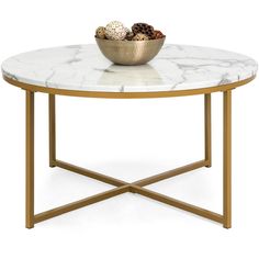 a marble coffee table with gold legs and a bowl of fruit on top, against a white background