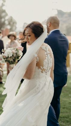 a bride and groom walking down the aisle