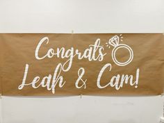 a sign that says congrats, leaf & camo on it with a diamond ring