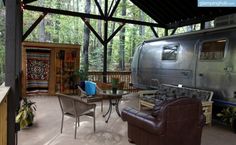 a living area with couches, tables and an airstream