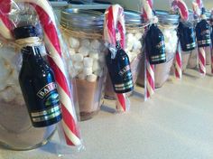 several jars filled with hot chocolate and marshmallows on a kitchen counter top