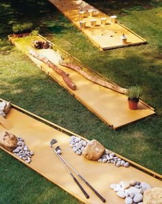 the backyard mini golf course is made out of wood and has two boards with holes in it