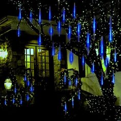 a house decorated for christmas with blue lights