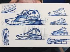 sketches of different shoes are shown in this drawing book, which is being held by someone's hand