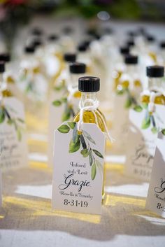 small bottles filled with olive oil sitting on top of a table