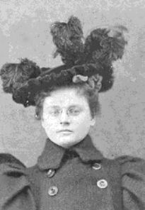 an old black and white photo of a woman with birds on her head