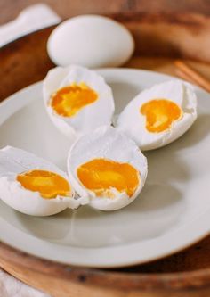 three hard boiled eggs on a plate with chopsticks