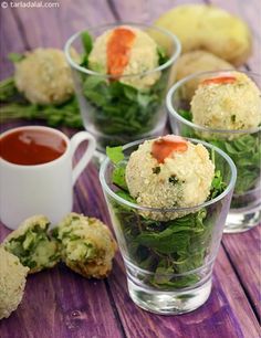 small cups filled with food sitting on top of a wooden table next to broccoli