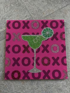 a painting of a green drink on a pink background with the word xoxo