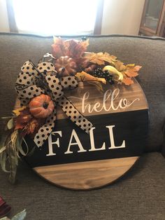 a wooden sign that says hello fall on it