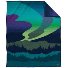 a blanket with an image of the northern lights in green, purple and blue colors