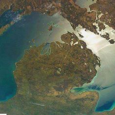 an aerial view of the water and land in this image is taken from space, looking down on it