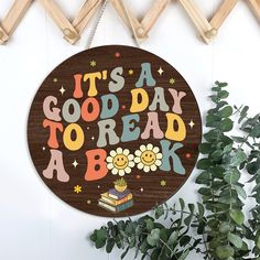 a wooden sign that says it's a good day to read a book