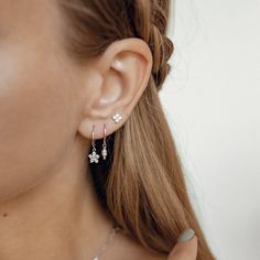 This pair of huggie earrings is made from 925 sterling silver and features a smooth hoop with a small flower (a floweret) pendant hanging from their lower edge, embellished with 6 tiny zirconia stones. They open and close with a hinged opening, also on the lower edge, and have a thin earpiece that threads comfortably through the earlobe. A timeless, graceful design that will work with a huge array of styles.  Also available in 18k gold plated sterling silver: https://www.etsy.com/listing/1067338248/floweret-huggie-earrings-gold-plated 🎁 Packaging: Beautifully packed in a box, ready for gifting. 🏷️ This product is made of sterling silver -- easily recognizable by its '925' stamp of authenticity. It is also hypoallergenic, making it suitable for people with sensitive or irritable skin. We Slogan Tees, Huggie Earrings Silver, Daisy Studs, Slip Dresses, Small Earrings Studs, Natural Pearl, Huggie Earrings, Earrings Sterling Silver, Sterling Silver Studs