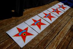 some red and blue stars are on a wooden table