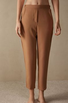 Full-length trousers featuring two pockets, faux back pocket and covered elasticated waist. Brown Tailored Bottoms With Straight Hem, Tailored Straight Hem Brown Bottoms, Elegant High-waisted Pants With Patch Pockets, Elegant Trousers With Patch Pockets, Tailored Pants With Pockets In Elastane, Tailored Elastane Pants With Pockets, Brown Tapered Leg Pants With Side Pockets, Straight Hem Pants With Elastic Waistband, Elastane Pants With Elastic Waistband And Straight Hem