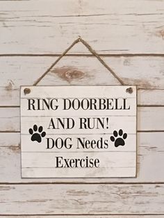 a sign that says ring dobble and run dog needs exercise hanging on the wall