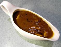 a spoon full of food sitting on top of a table