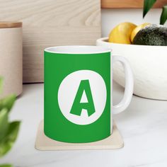 a green coffee mug sitting on top of a coaster