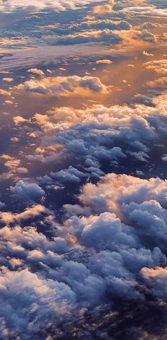 the sky is filled with clouds as seen from an airplane