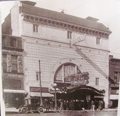 an old black and white photo of people in front of a theater