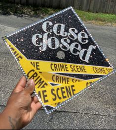 a hand holding up a sign that says case closed