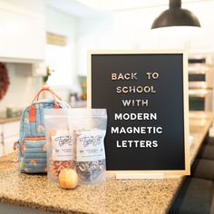 back to school with modern magnetic letters on the counter in front of a chalkboard