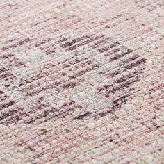 an area rug with pink and brown colors on it, including the center piece in the middle