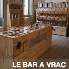 an old fashioned wooden shop with many items in it's display cases and the words le bar a vrac written below