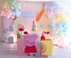 a peppa pig birthday party with balloons and decorations