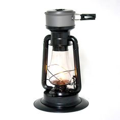 an old fashioned lantern is lit up on a white background with the light turned on